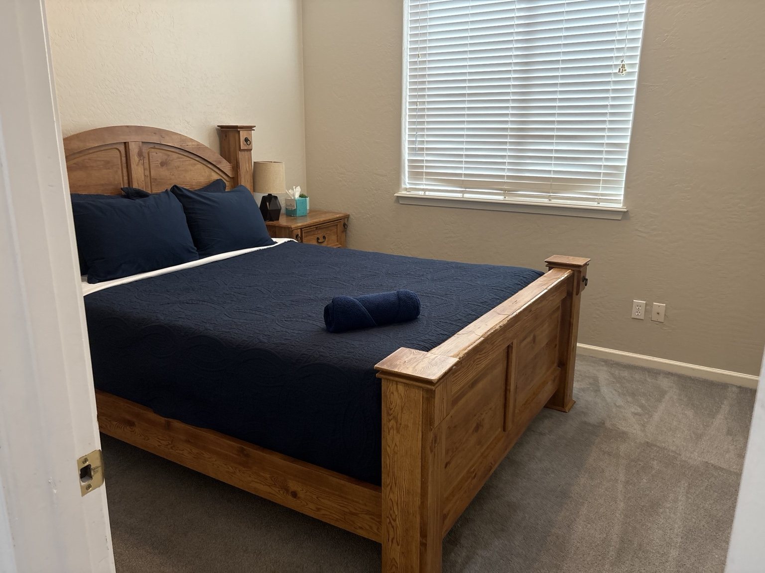 Bedroom with clean bedding and a folded towel