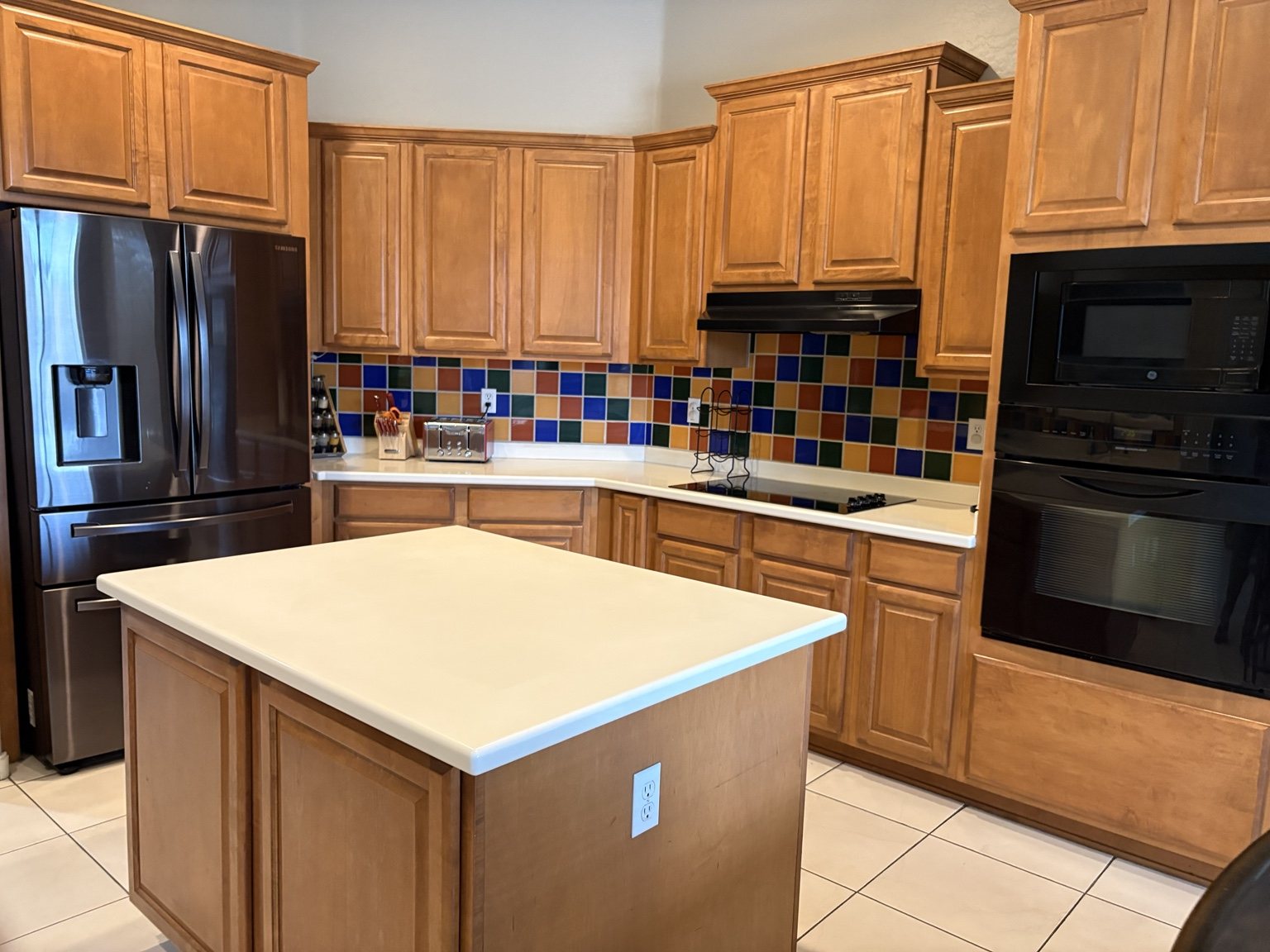 Clean kitchen with a tidy island and appliance exteriors